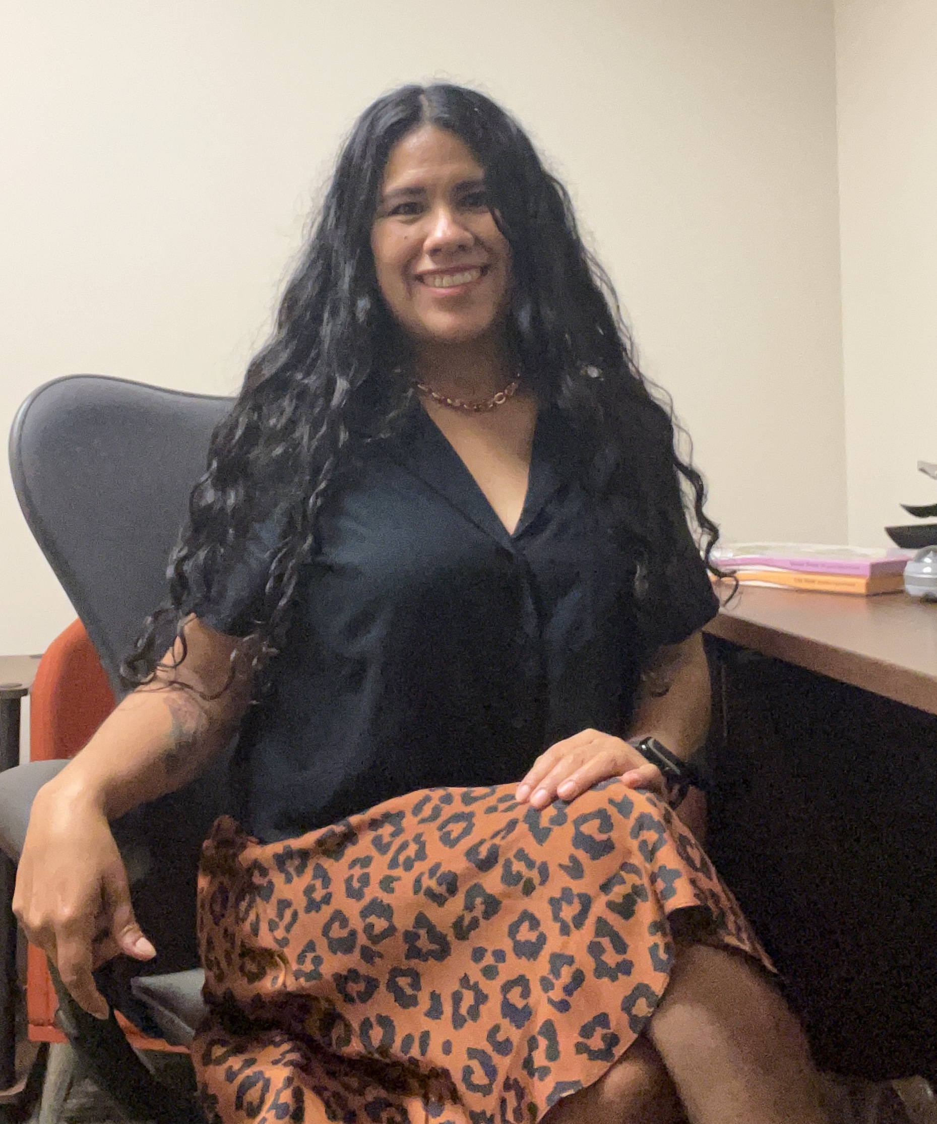 Jessy Perez sitting at her office desk